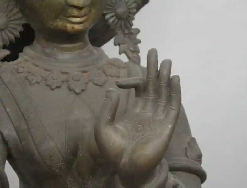 Bronze statue of Laxmi, cross on the hand, four-point symbol